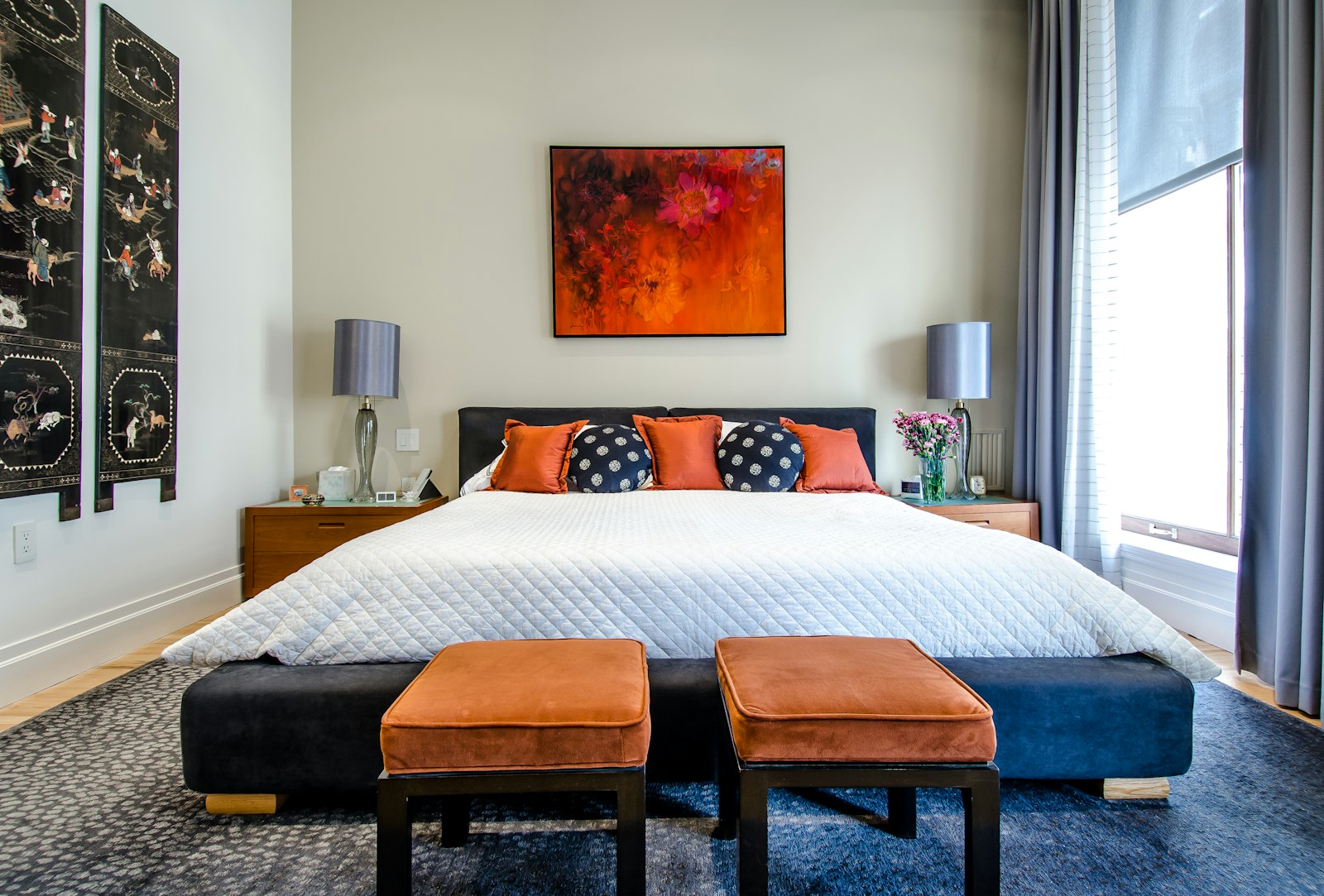 Layered neutral bedding in a comfortable everyday bedroom.